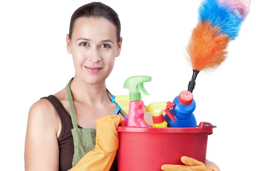 Carpet cleaning technician preparing equipment with safety focus