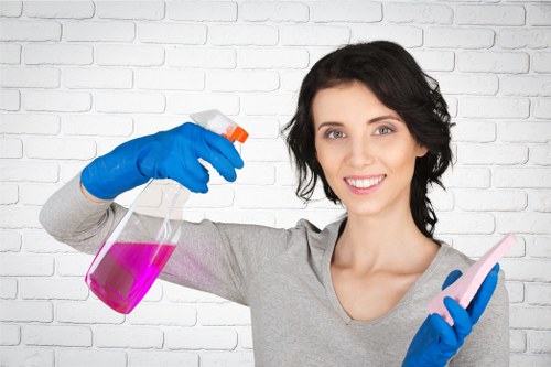 Local cleaner treating an armchair upholstery stain in Edgware